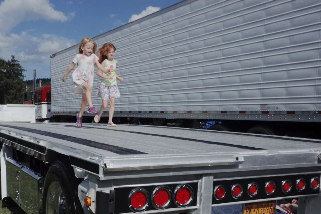 jeunes filles qui courent sur la remorque d'un camion