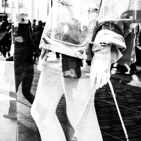Laurence Givry · 07/03/2026 · 900 x 900 Cette photographie en noir et blanc met en scène un personnage vêtu d’un costume blanc, évoquant un style théâtral ou carnavalesque. Le sujet principal semble porter une perruque et un masque, avec des éléments décoratifs sur les épaules.La composition est dynamique, avec un cadrage serré sur les jambes et le bas du corps, créant un effet de mouvement. L’arrière-plan flou suggère une foule en mouvement, renforçant l’ambiance animée. La lumière est contrastée, avec des ombres marquées, accentuant les détails du costume.L’absence de couleurs et les jeux d’ombres confèrent une ambiance mystérieuse et artistique.