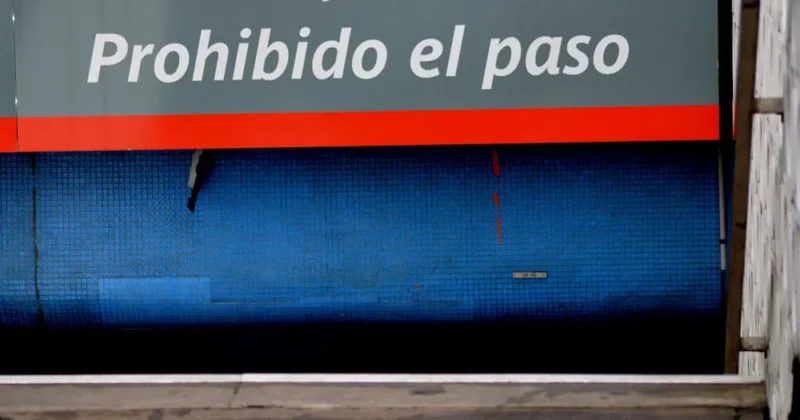 Franck T. · 31/12/2018 · 1000 x 525 Cette photographie montre principalement un panneau avec l'inscription *« Prohibido el paso »* sur une surface métallique bleue et rouillée. Le sujet principal est ce message en espagnol, indiquant une interdiction de passage.La composition est simple et centrée sur le texte. Le cadrage est serré, mettant en valeur les détails de la surface et du message. La lumière semble naturelle, avec des contrastes doux. Les couleurs dominantes sont le bleu métallique, le rouge de la bande et des teintes grises dues à la rouille. Le style est documentaire et réaliste, évoquant une ambiance industrielle et un peu négligée.