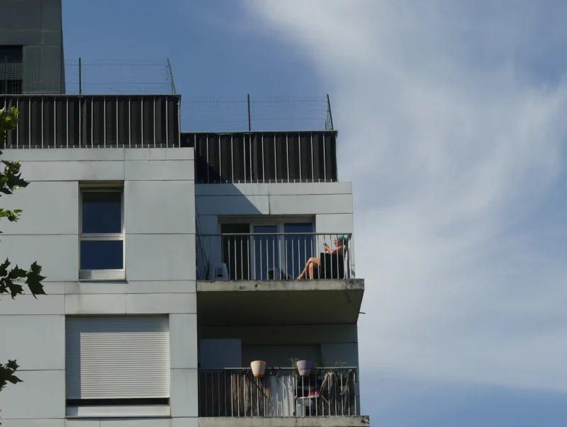 Marine · 14/06/2026 · 3218 x 2424 Cette photographie met en scène un immeuble moderne avec des balcons en saillie. Le sujet principal est l’architecture minimaliste et contemporaine, marquée par des lignes épurées et des matériaux clairs.La composition joue sur les jeux de pleins et de vides, avec des balcons en retrait et des fenêtres alignées. Le cadrage est serré, mettant en valeur les détails architecturaux.La lumière est naturelle et douce, créant des contrastes subtils. Les couleurs dominantes sont les tons gris-beige et blancs, renforçant l’aspect moderne et sobre.L’ambiance est calme et urbaine, évoquant une architecture fonctionnelle et esthétique.