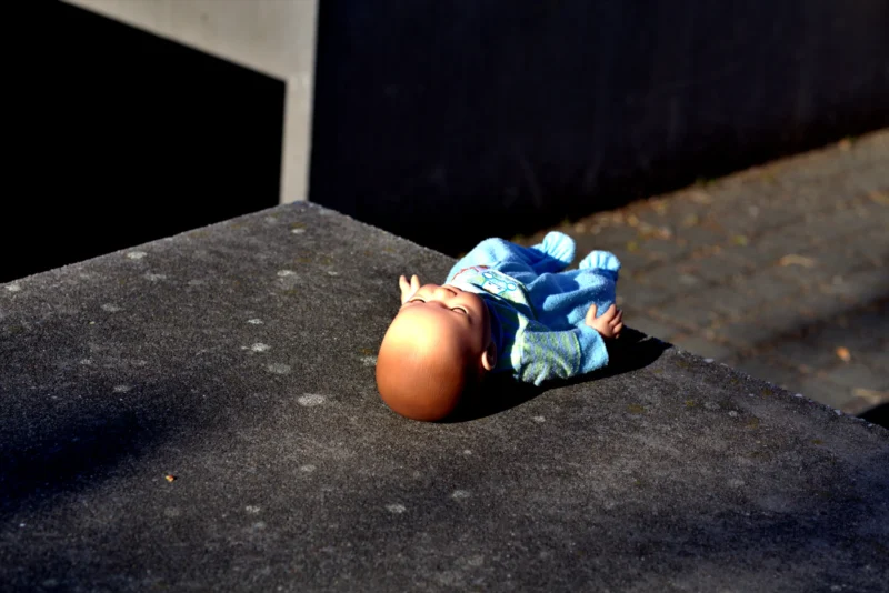 Fabienne · 01/05/2026 · 5496 x 3670 Cette photographie met en scène un **œuf en plastique bleu** avec une petite figurine en forme de poulet émergeant, posé sur une surface sombre et rugueuse.La **composition** est simple et épurée, avec un **cadrage serré** centré sur l'objet. La **lumière**, naturelle et contrastée, crée des ombres marquées, accentuant le réalisme et la texture. Les **couleurs dominantes** sont le bleu vif de l'œuf et les tons sombres du support, renforçant un effet dramatique.Le **style** est minimaliste et presque surréaliste, évoquant une **ambiance mystérieuse et poétique**, entre innocence et étrangeté.