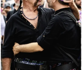 Thierry · 03/10/2026 · 1600 x 2400 Deux hommes en kilt colorés et chapeaux ajustant leurs accessoires lors d'une manifestation festive et animée