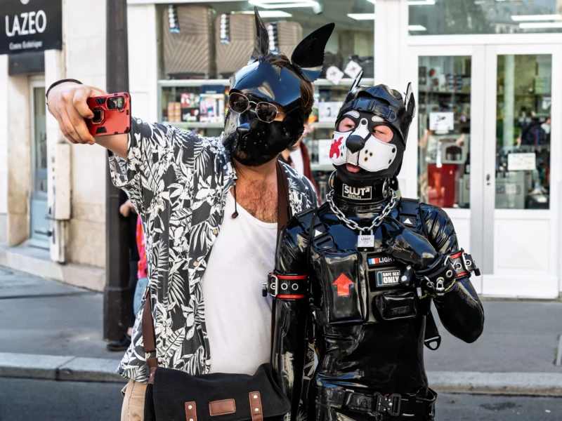 Daniel · 03/10/2026 · 2400 x 1800 Trois personnes déguisées en costumes originaux posent pour une photo en ville, dont une en tenue inspirée de Batman et